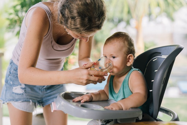 Child drinking to rehydrate to represent childhood illnesses