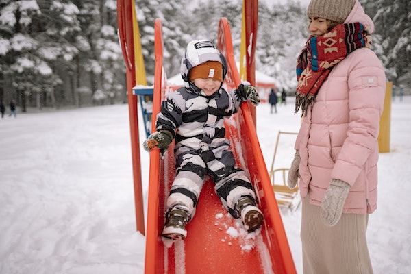 Child playing at the park wearing thermals to represent keeping your children warm