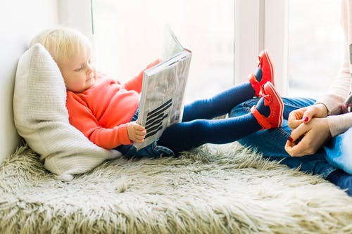 A little girl reading a book