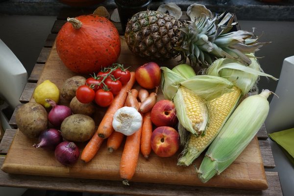 A chopping board full of fruit and vegetables