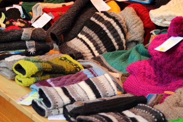 A table full of colourful hats and gloves