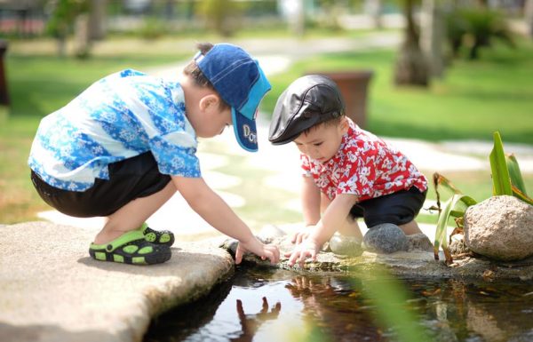 Two boys playing in a stream