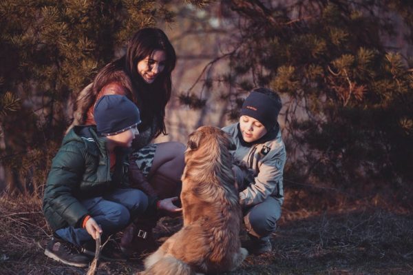 A family and dog in a forest