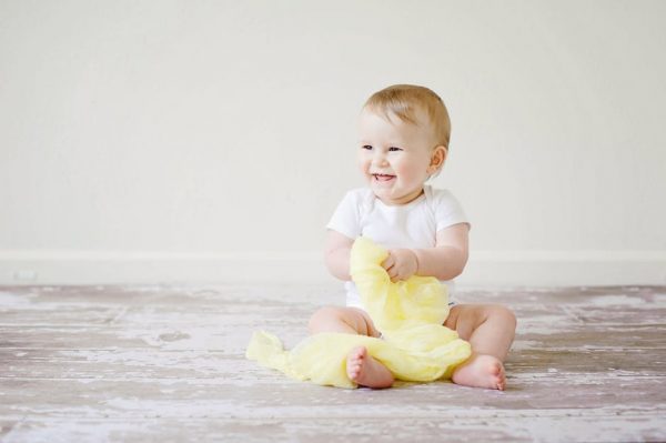 Baby playing with tissue paper