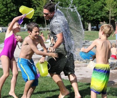 A family having a water fight outdoors