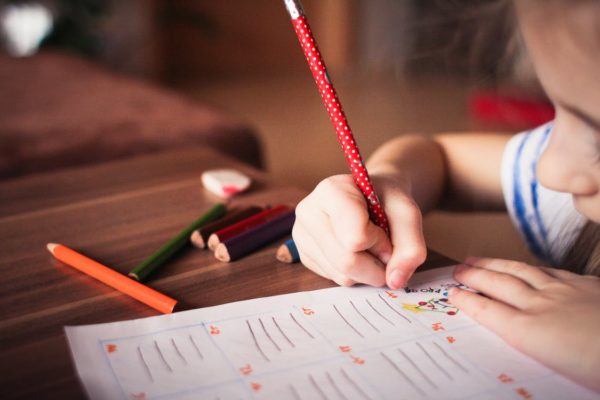 girl writing nursery to represent celebrating pride with children