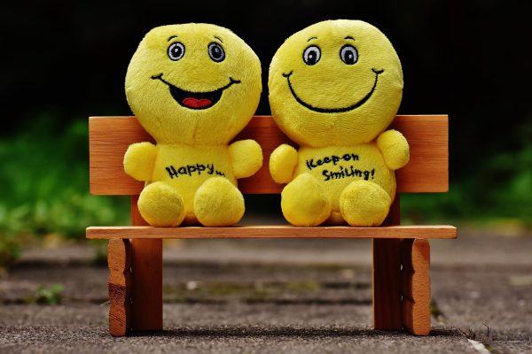 Two toys saying happy and keep on smiling