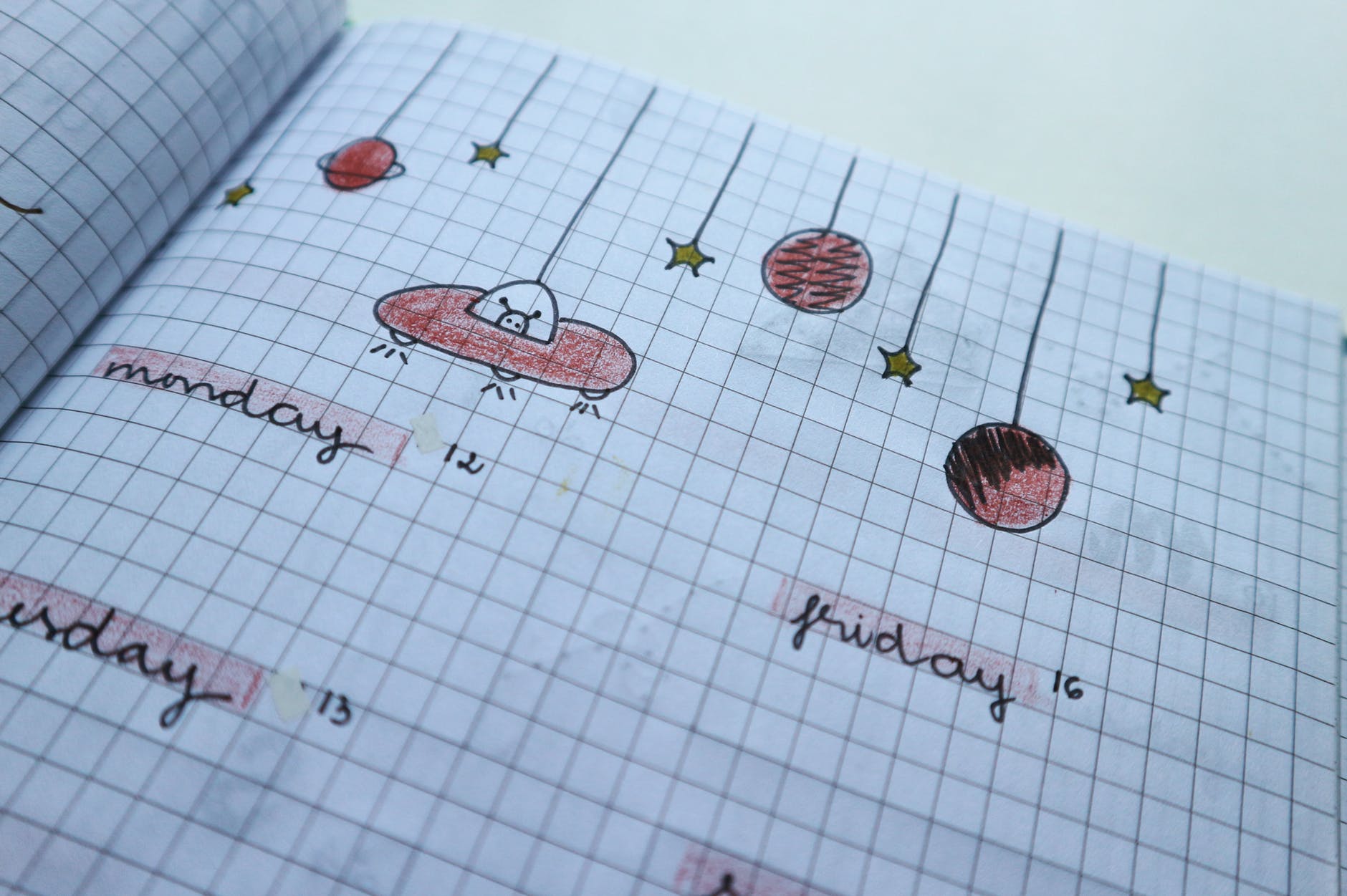 Notebook with doodles and the days of the week on it