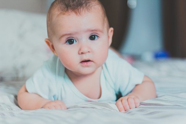 A baby lying on his stomach