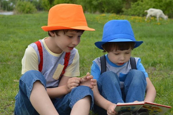 two boys reading a book