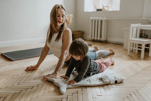 mother and daughter doing yoga