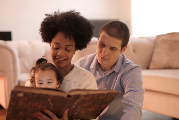 parents and baby reading