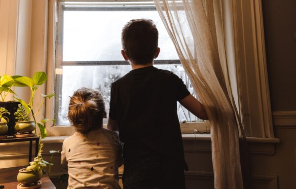 two boys at home looking out the window