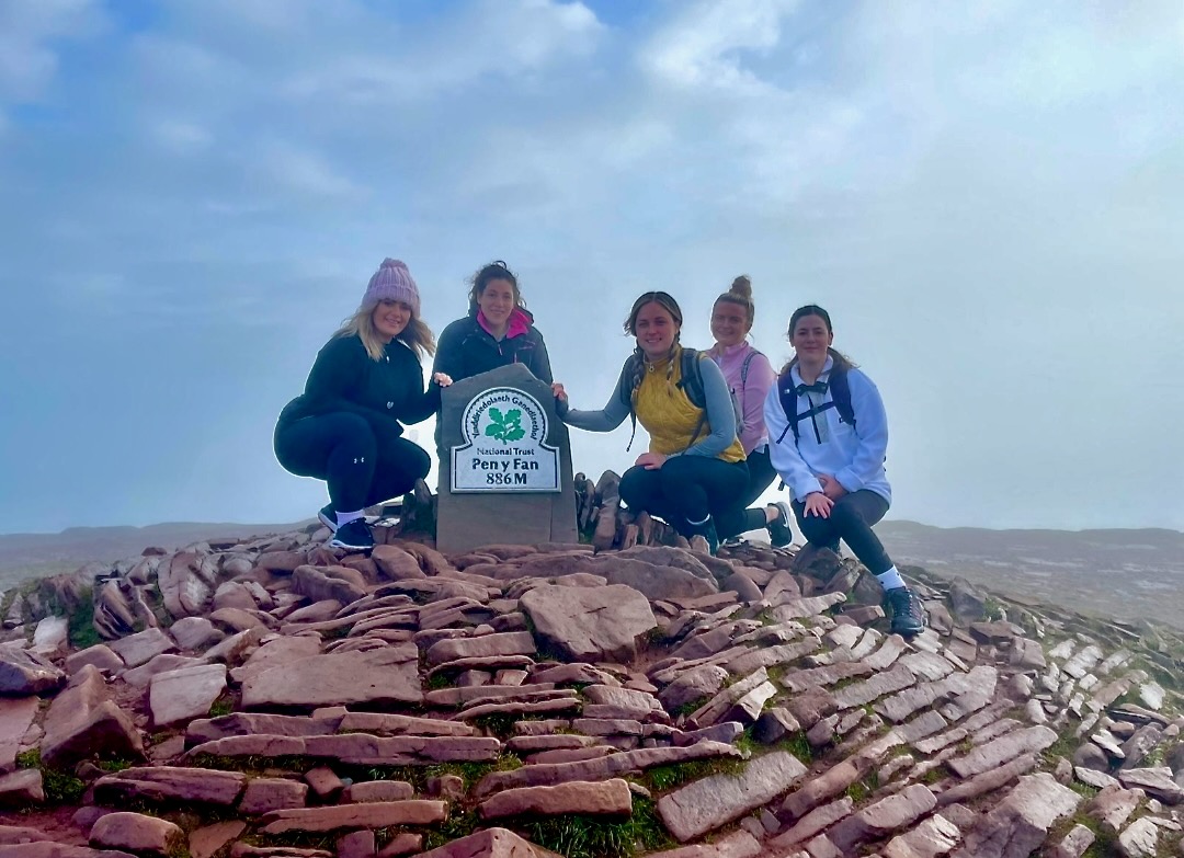 A photo of the Schoolhouse team at the top of a walking trail after training for their Snowdon challenge