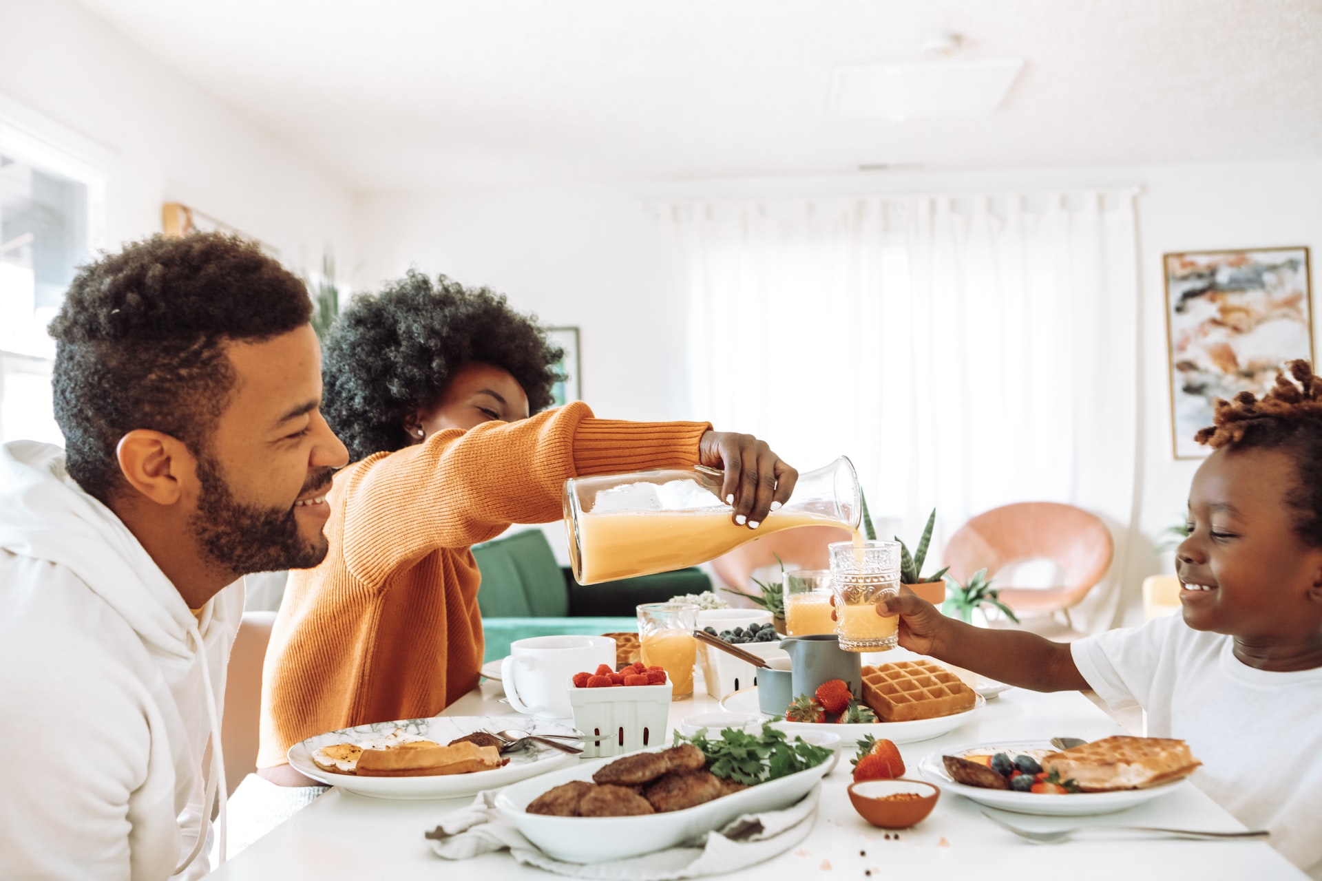 A family eating breakfast to represent sharing a family meal