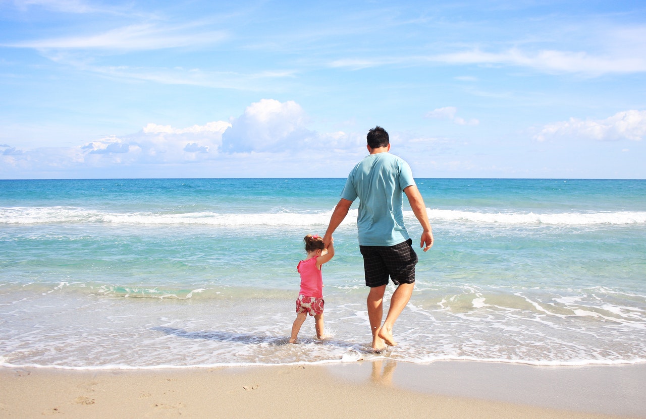 Father and daughter at the beach to represent memories to make with your children
