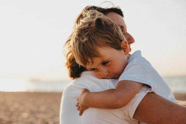 A child hugging their parent to represent the benefits of sharing a family meal
