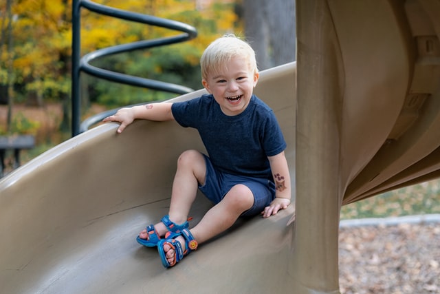 Toddler on a slide to represent family days out in Wales