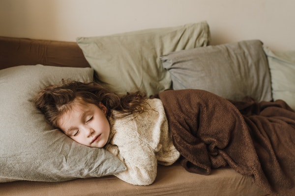 A child sleeping to represent back-to-school anxiety