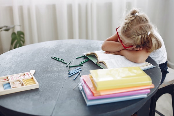 A young child looking bored to represent back-to-school anxiety