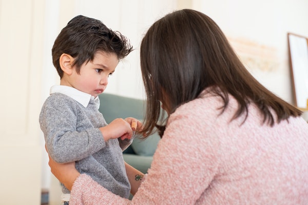 Mother talking to her son to represent back-to-school anxiety