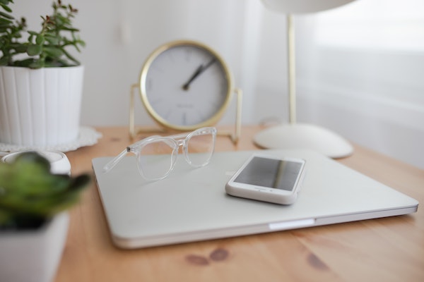 A closed laptop and phone to represent how to switch off after work as a parent