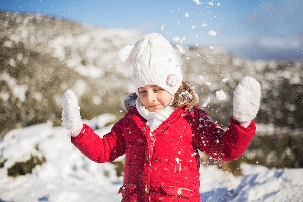 Child in coat, hat and gloves to represent keeping your children warm 